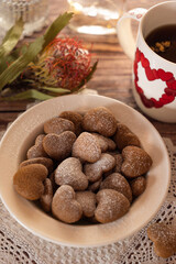 talerka with gingerbread - hearts on the table with a vase and a flower