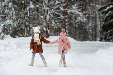 children run and play in the winter forest