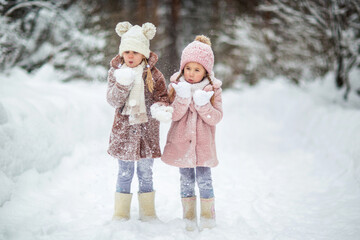 Fototapeta premium children run and play in the winter forest