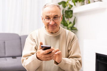 Close up of man hands using smartphone over white table