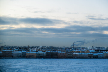 Fototapeta na wymiar St. Petersburg, Russia - December, 2021: View of frozen Neva River and city center in early morning.