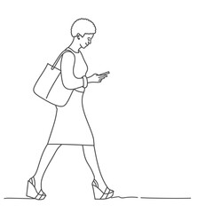 African business woman with handbag and smartphone is walking.