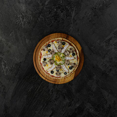Italian pizza with chicken and mushrooms on a wooden dark background. top view