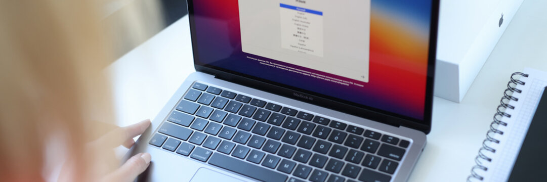 Woman Choosing Language On New Laptop Apple MacBook Air Closeup