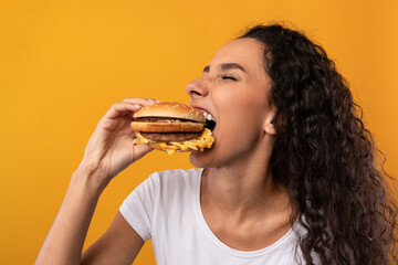 Funny Hungry Latin Lady Holding Burger Biting Sandwich At Studio
