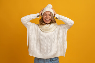 young smiling happy pretty blond woman wearing white knitted sweater, scarf and hat