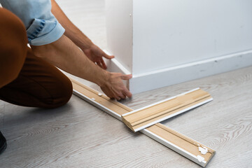 Installing the new skirting board after changing the parquet