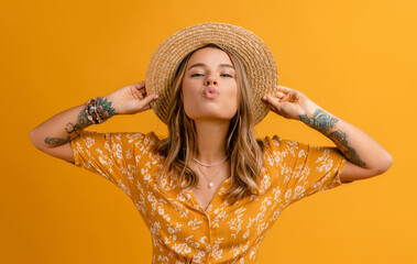 beautiful attractive stylish woman in yellow dress and straw hat