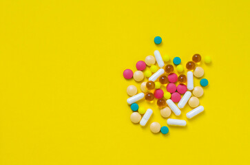 a lot of medical drugs on a yellow background flatlay