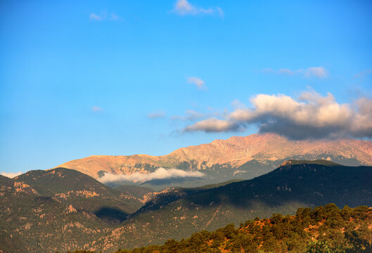 Image Of Sunrise Striking Pikes Peak In Colorado As Low Lying Clouds Hover Near The Mountain