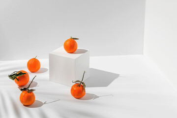 Creative composition made of fresh mandarin fruits on white background with shadows. Healthy food...