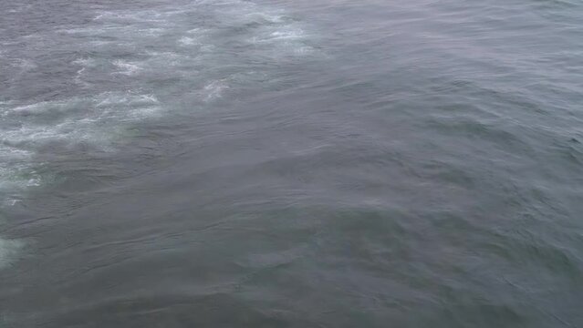 The waves are on the sea surface. Top view. Sea breeze. A wave in the ocean.