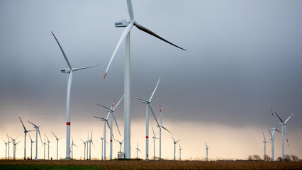 Wind Turbines, copy space on the right, dramatic, warm grey sky