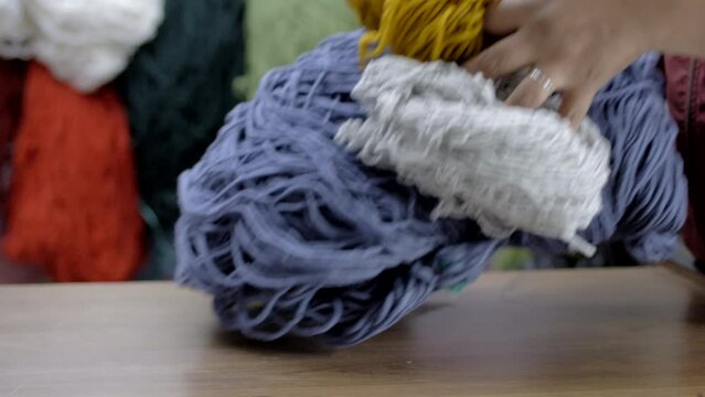 wool thread passing from hand to hand