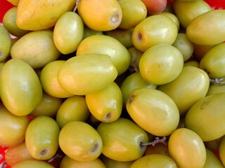 Group or collection of Jujubes in plastic basket. Fresh ripe jujube. Delicious Asian Pakistani...