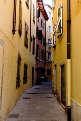 Fototapeta na wymiar Narrow color street in Trieste, Italy - colorful houses in a row