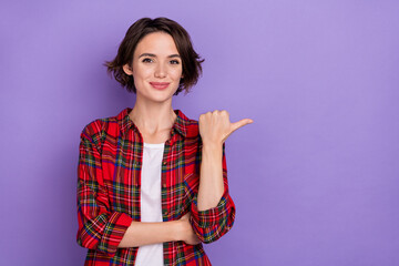 Photo of cute young bob hairdo lady indicate promo wear plaid shirt isolated on purple color...