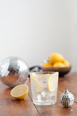Water with lemon in glass on wooden table