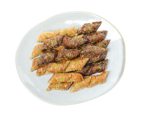 Plate of delicious baklava with pistachio nuts on white background, top view