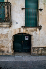 Small old wooden door. Historical center of Copertino, Italy, region Apulia, province Lecce...