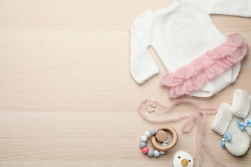 Fototapeta na wymiar Cute baby stuff on wooden background, flat lay. Space for text