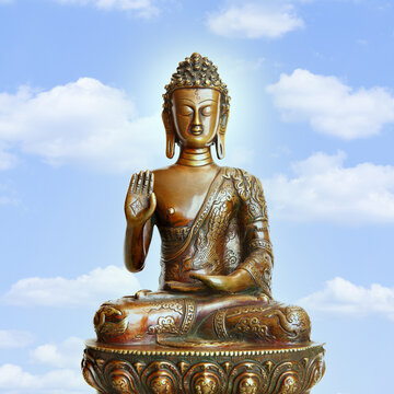 Buddha and the blue sky with clouds
