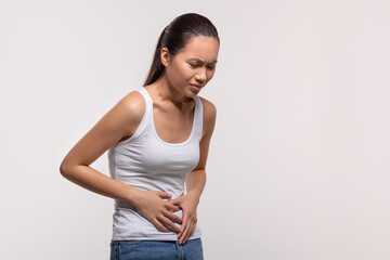 Sick chinese lady suffering from abdominal pain caused by diarrhea
