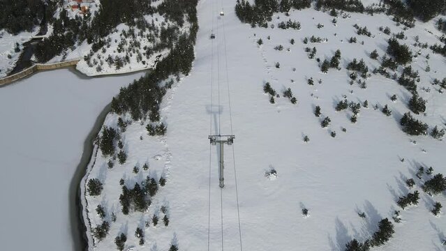 Zlatibor Mountain Resort at Winter, Serbia. Aerial View of Gondola Cables Towers and Cabins in White Snowy Landscape, Revealing Drone Shot