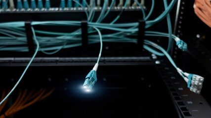 Close up fiber optic and hub in datacenter.