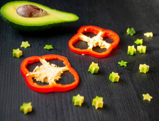 Red pepper slices and star-shaped pieces of avocado