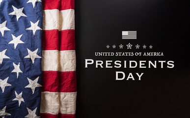 Happy presidents day concept with flag of the United States and the text on dark  background.