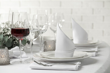 Glass of delicious wine and elegant table setting in restaurant