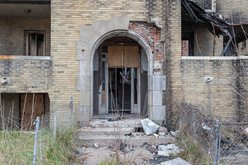 Fototapeta na wymiar Decaying entrance to abandoned apartment building