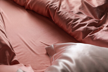 Fototapeta na wymiar Closeup view of bed with beautiful silk linens