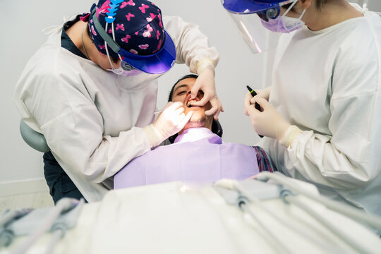 dentist extracting a tooth in his office