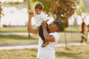 Father and son having fun in summer park