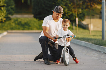 Father and son having fun in summer park