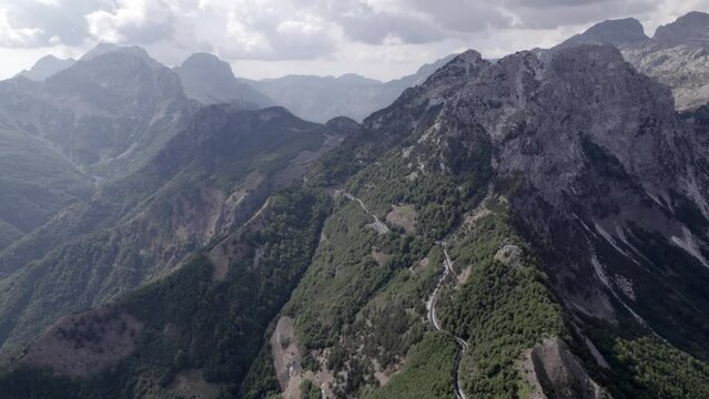 Drone video of "Frontal" plane, advancing on the highest of the sh21 the Theth mountain pass in albania, Gjecaj.
The mountains can be seen in the background, possibly Mount Korab.
valbona valley