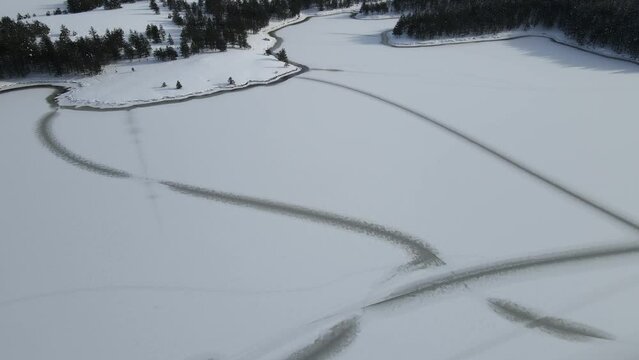 Zlatibor Mountain Resort, Serbia. Aerial View of Frozen Ribnica Lake in White Snowy Winter Landscape, Drone Shot