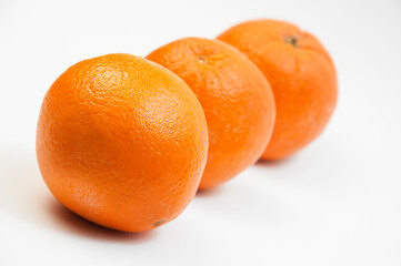 juicy oranges on a white background. sweet big tangerines on the table.orange citrus fruits on a light texture