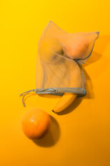  Fruits in a disposable bag on a yellow background. High quality photo
