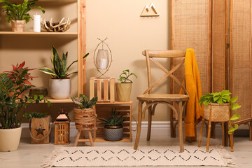 Fototapeta na wymiar Room interior with wooden furniture, houseplants and stylish accessories
