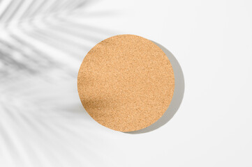 Trendy Summer layout made with bamboo round card on white background. Exotic shadow concept with copy space. Tropical palm leaf shadow on flat bamboo blank.