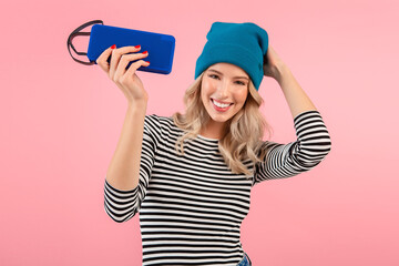 young woman holding music speaker