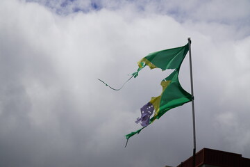 Tattered flag of Brazil, no order and also no progress as in the inscription of the banner (Ordem e...
