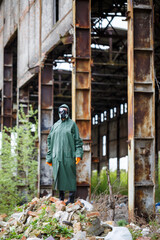 A man with a protective mask and protective clothing examines the danger zone. Ecological catastrophe. Dangerous toxic zone