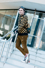 modern man standing in an outdoor staircase