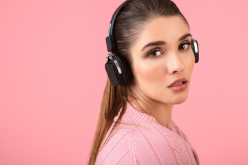 young woman listening to music in headphones