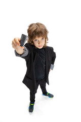Portrait of liitle boy, kid in image of stylish hairdresser, barber isolated on white studio background. Concept of occupation, modern specialists, childhood