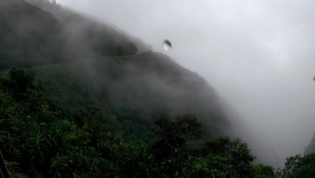POV from the opening door of bus driving on edge of Death Road, Bolivia